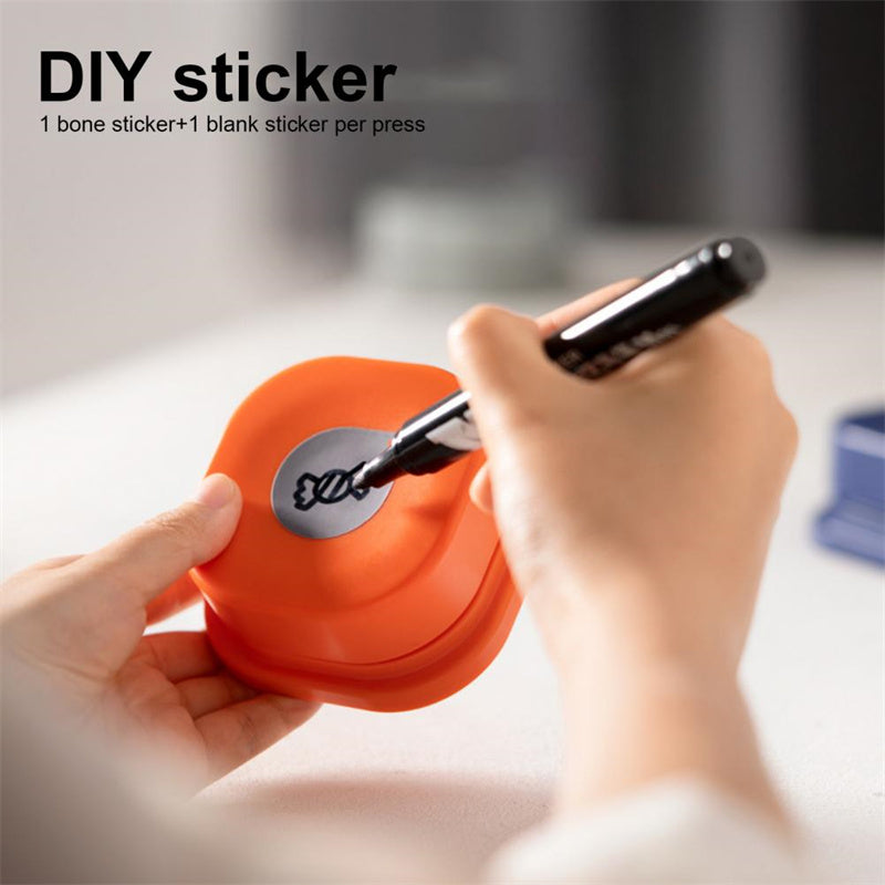 Hand using a tool to apply a sticker on an orange object with text about DIY stickers.