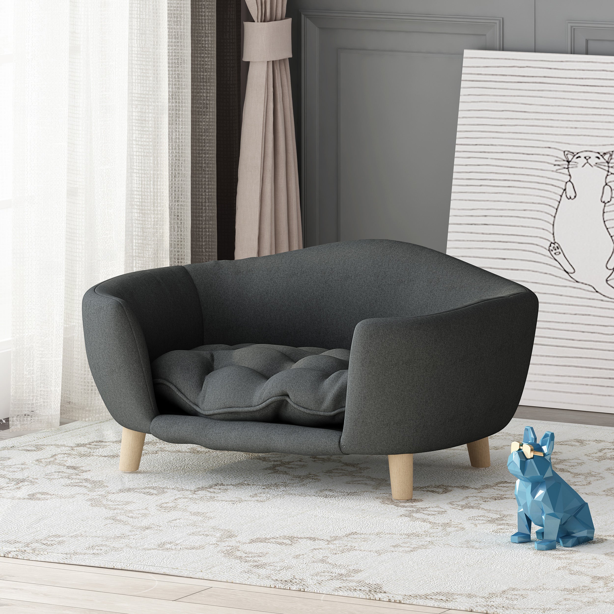 Gray pet bed with wooden legs in a room setting with a blue dog figurine and white wall art.