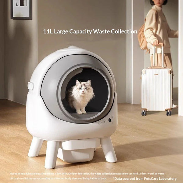 White fluffy cat sitting inside automatic self-cleaning cat litter box with large capacity waste collection, in a modern home interior.