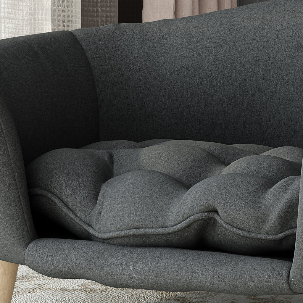 Gray cushion on a gray sofa with a textured wall in the background