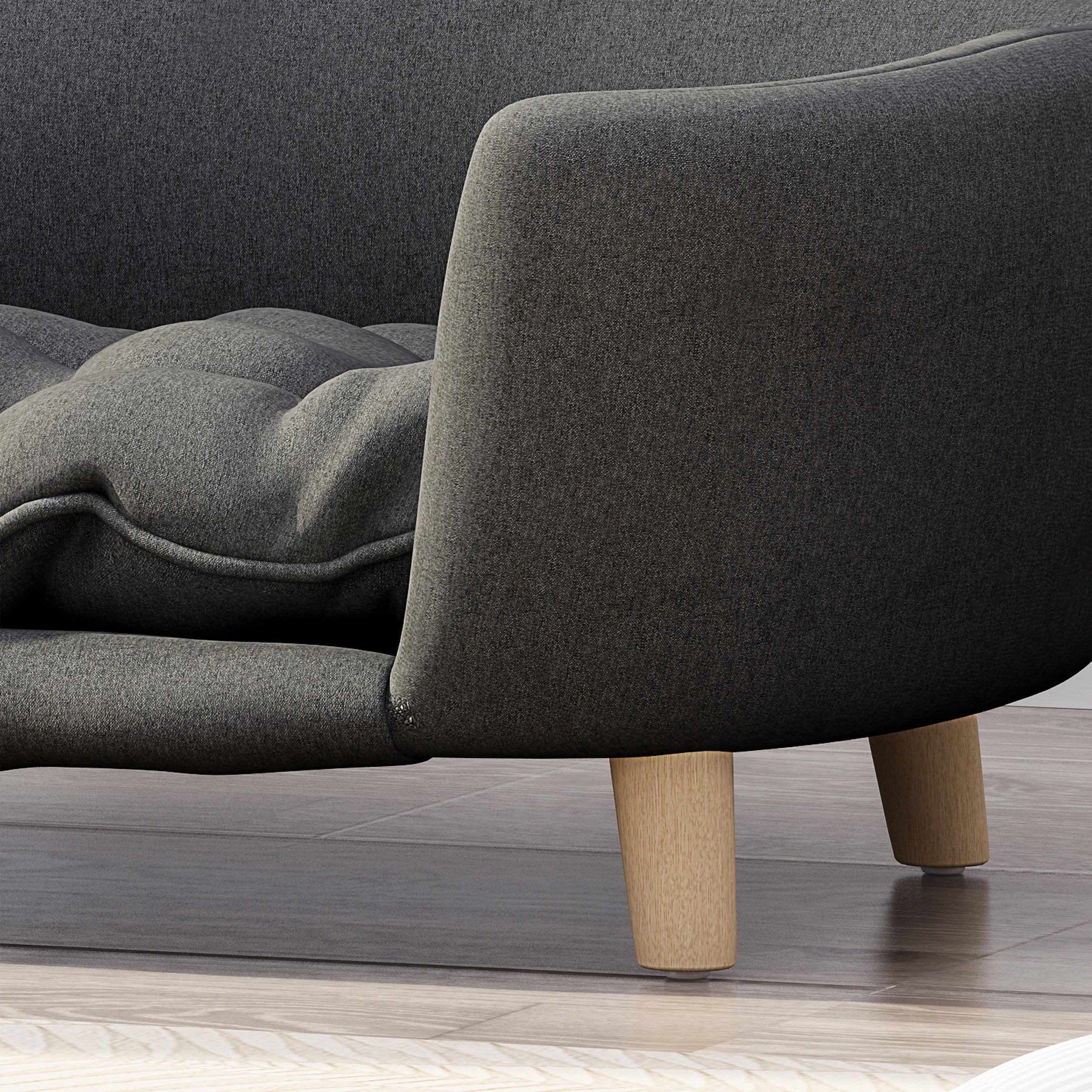 Gray upholstered chair with wooden legs on a wooden floor