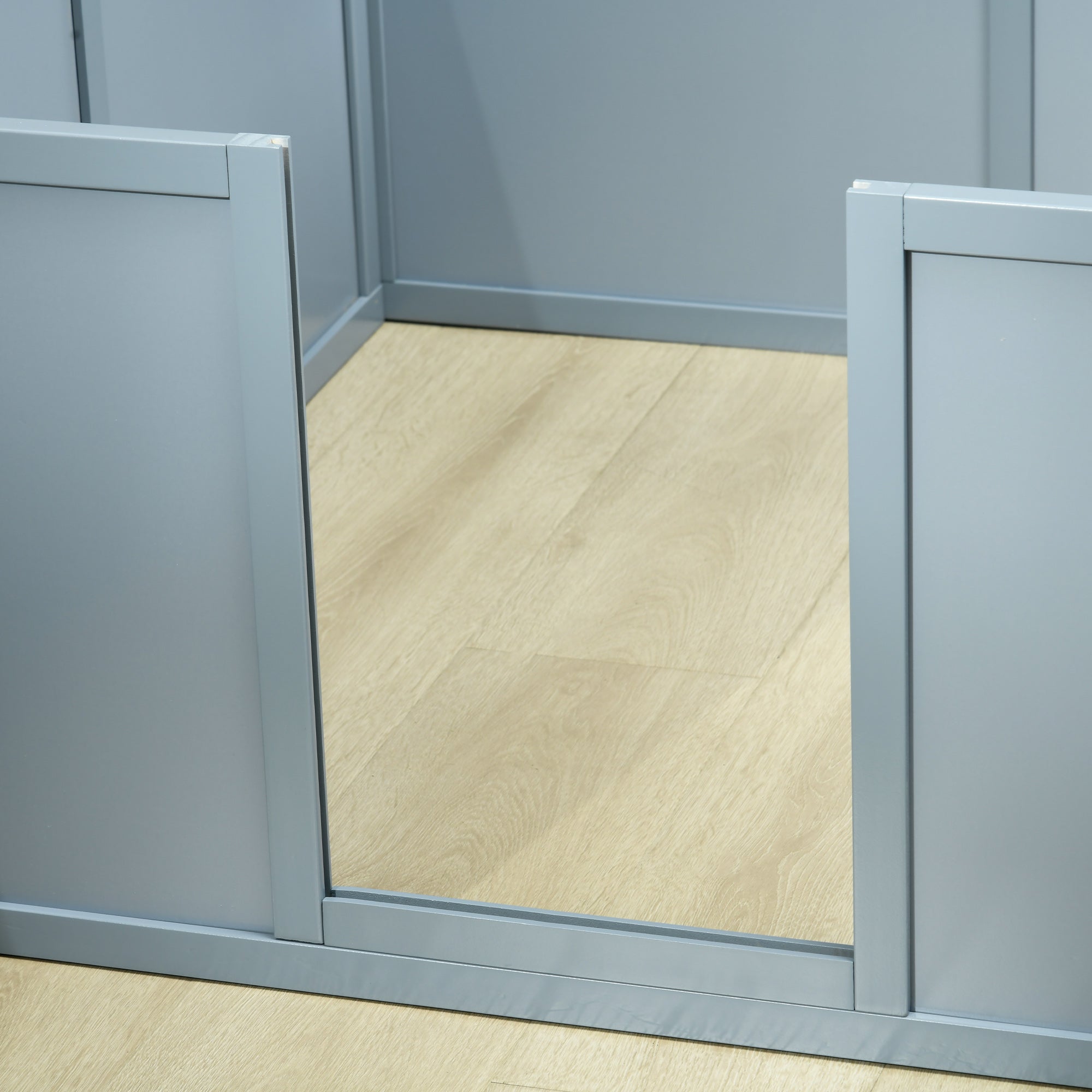 Gray cabinets with a wooden floor and wall in the background